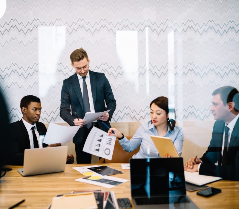 multiethnic-coworkers-negotiating-in-office-2023-12-21-13-47-02-utc
